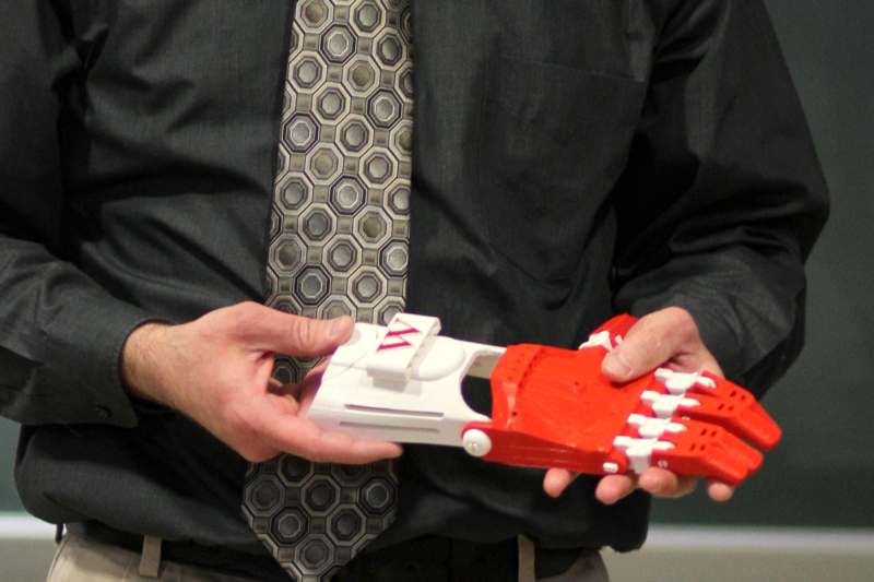 a man holding a red and white robot