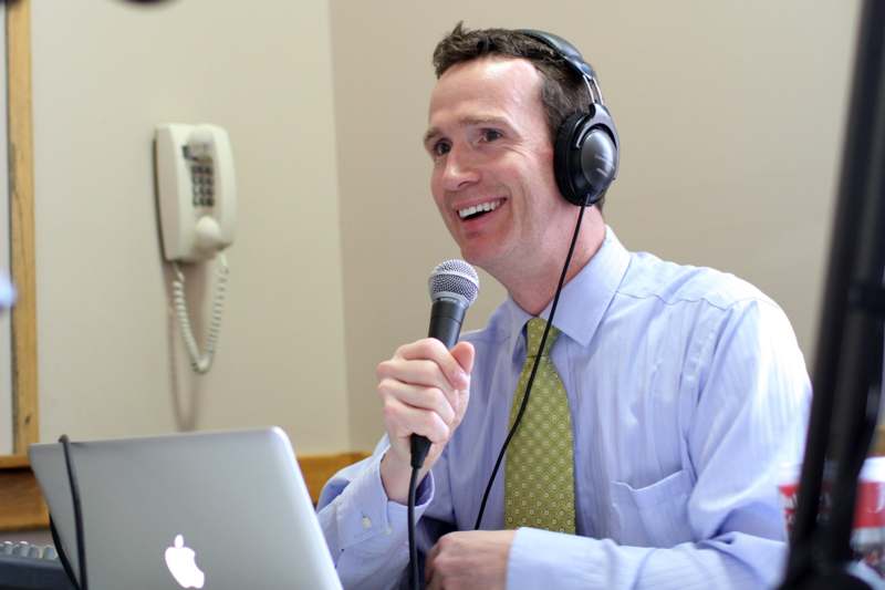 a man wearing headphones and holding a microphone