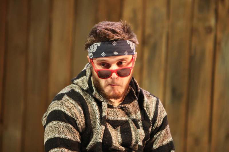 a man wearing sunglasses and a bandana
