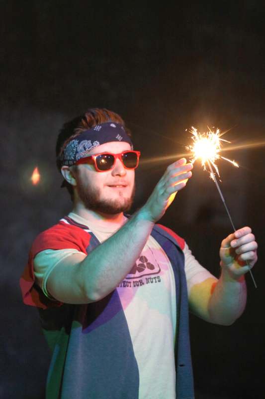a man holding a sparkler