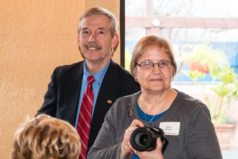 a man and woman holding a camera