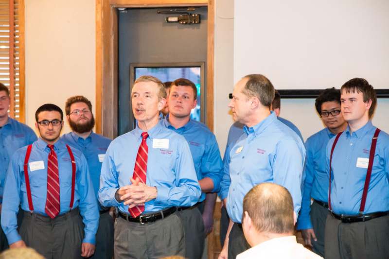 a group of men in blue shirts