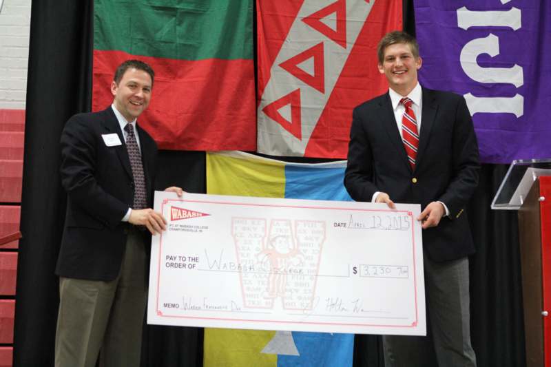 men holding a large check