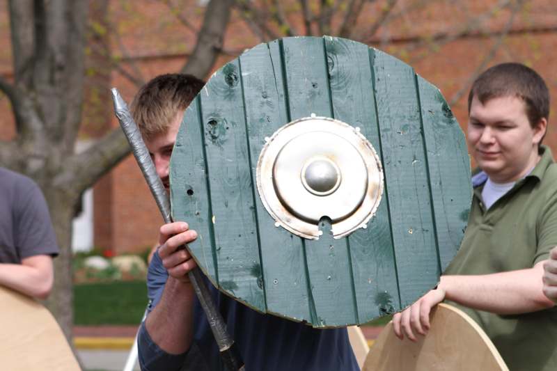 a man holding a shield and spear