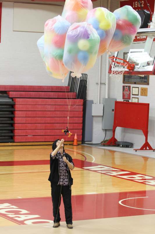 a person holding balloons in the air