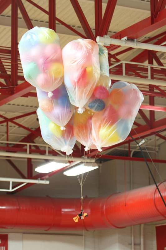 a group of balloons from a ceiling