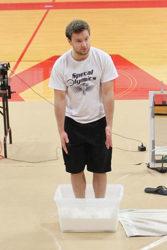 a man standing in a plastic container