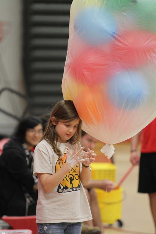 a girl holding a large balloon