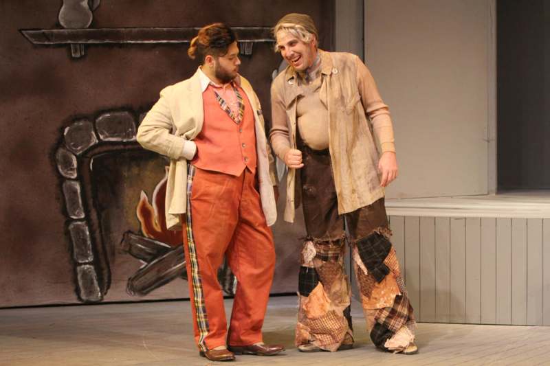 two men in clothing on a stage