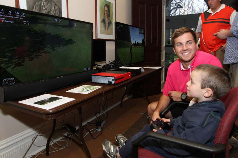 a man and a boy playing video games