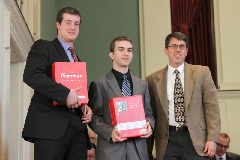 a group of men holding red boxes