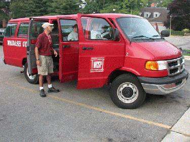 a red van with a man standing in the back