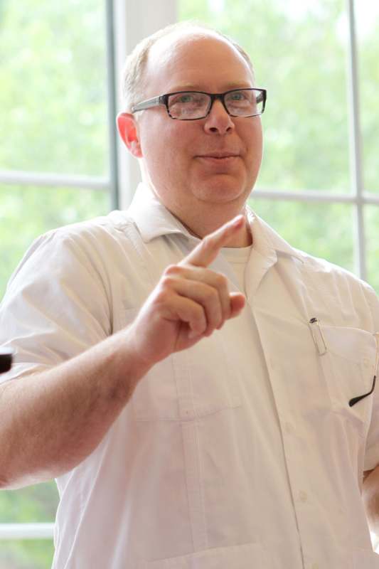 a man wearing glasses pointing at something