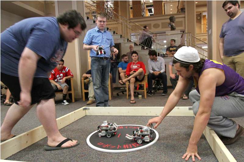 a group of men playing with robots