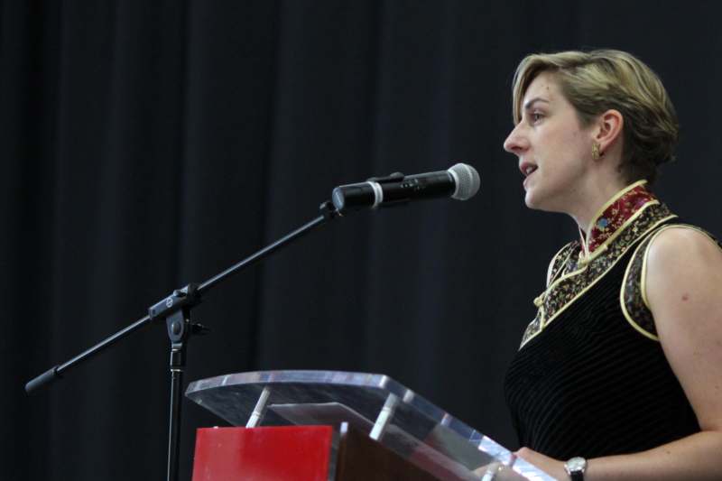 a woman speaking into a microphone