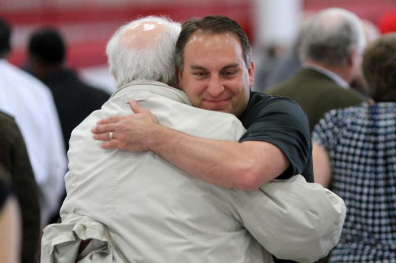 a man hugging an older man