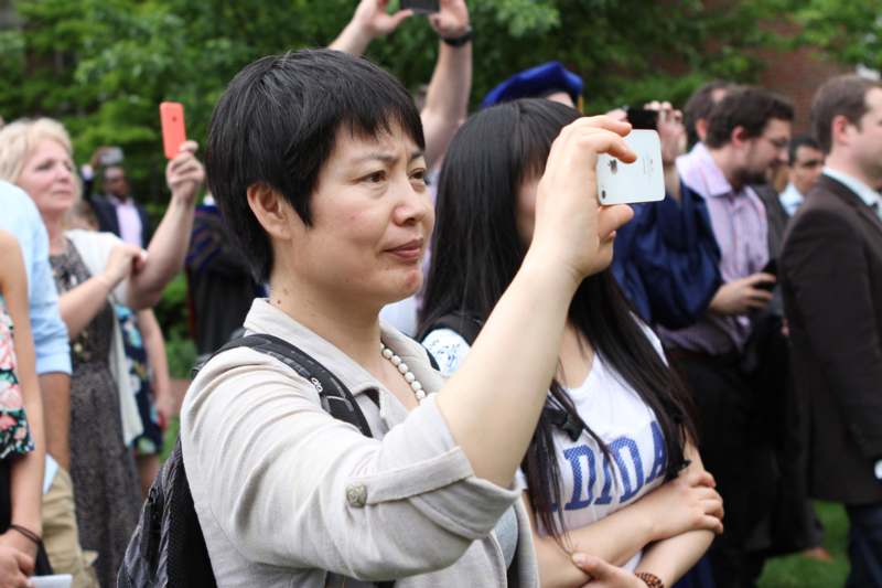 a woman taking a picture of a group of people