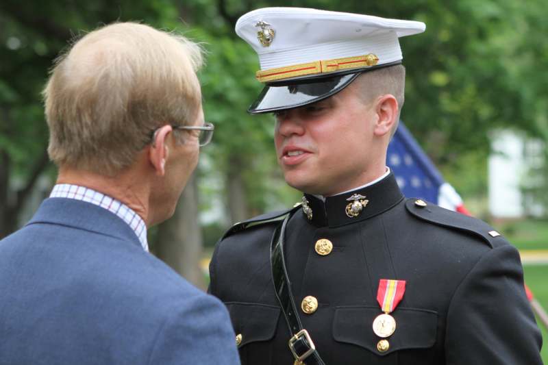 a man in a military uniform talking to a man