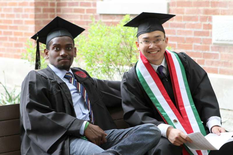 a couple of men in graduation gowns and caps