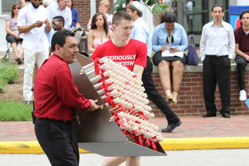 a man carrying a large box of white and red objects