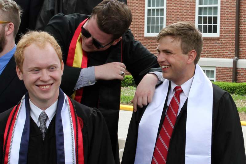 a group of men wearing graduation gowns