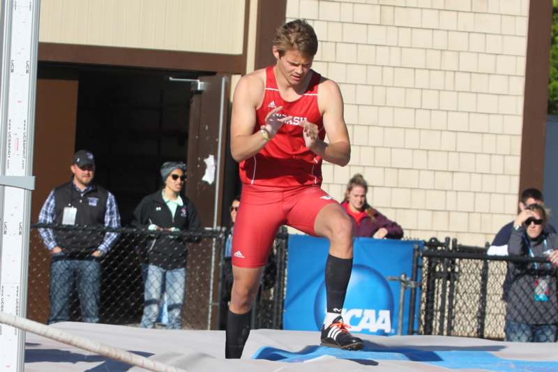 a man in a red shirt running on a mat