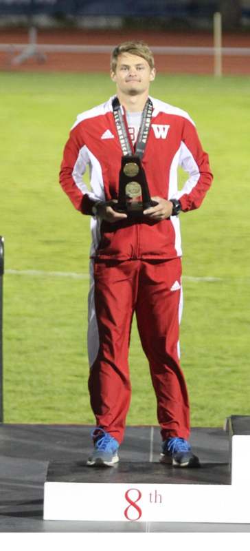 a man holding a trophy