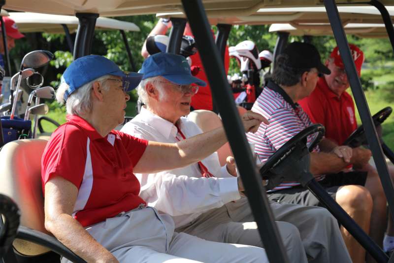 a group of people in a golf cart