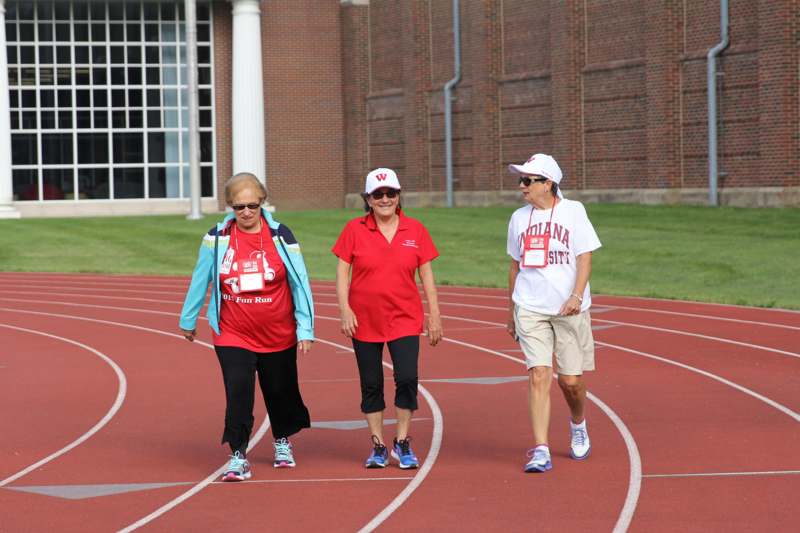 a group of women walking on a track
