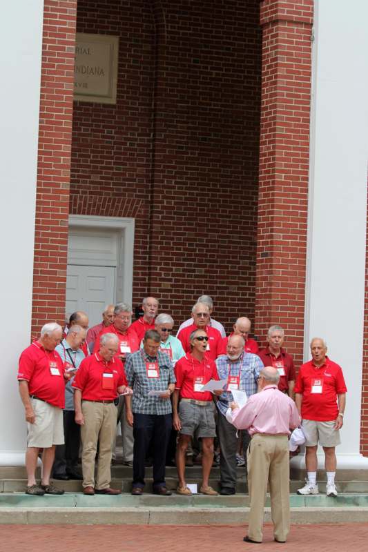a group of people standing in front of a brick building