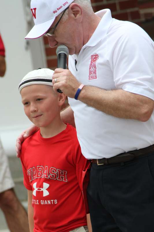a man holding a microphone and a boy