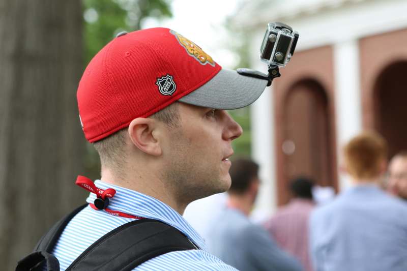 a man wearing a red hat with a camera attached to his head