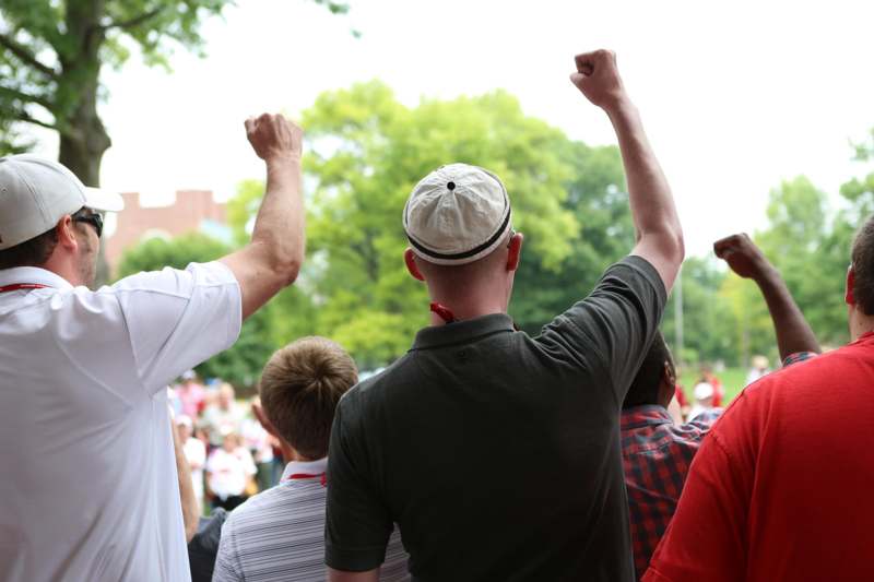 a group of people with their arms raised