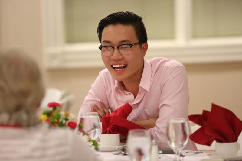 a man smiling at a table