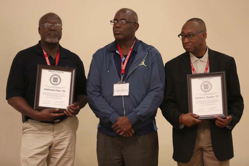a group of men holding certificates