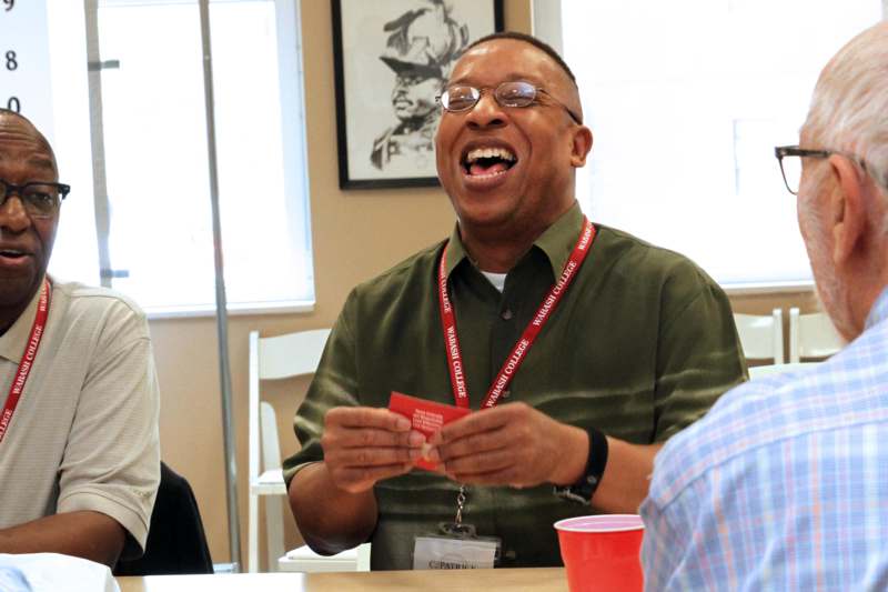 a man laughing at a table