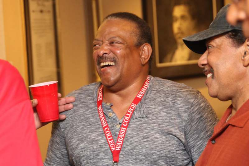 a man holding a red cup and smiling
