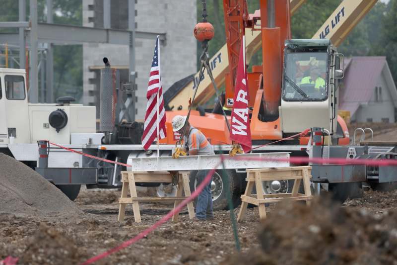 a man in a hardhat holding a flag