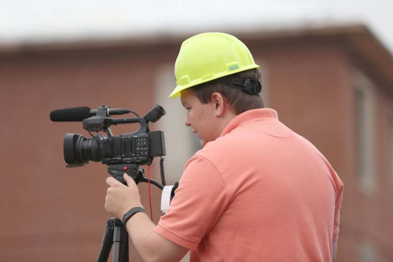 a man wearing a hard hat and holding a camera