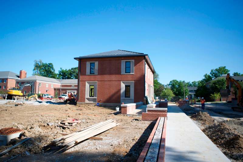 a building under construction with a path and a building