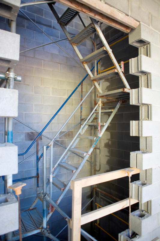 a metal stairs in a brick wall