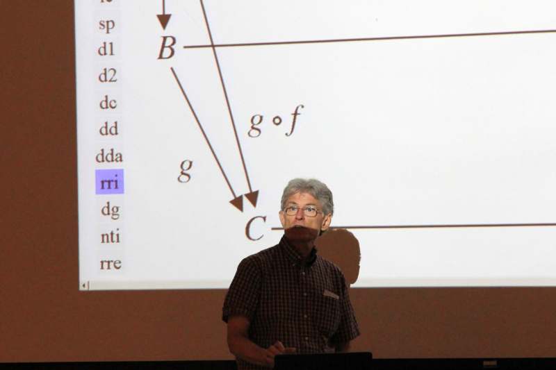 a man standing in front of a projection screen