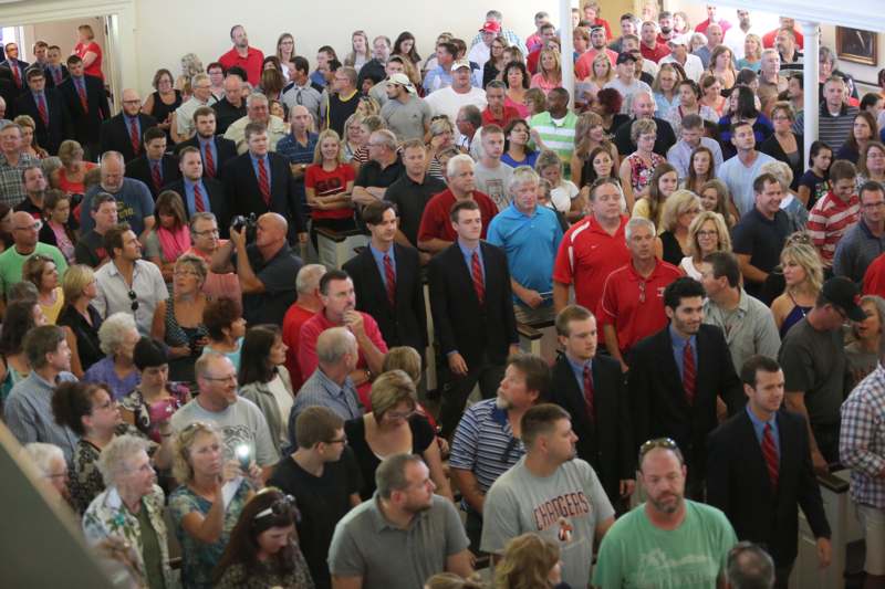 a large group of people standing in a room