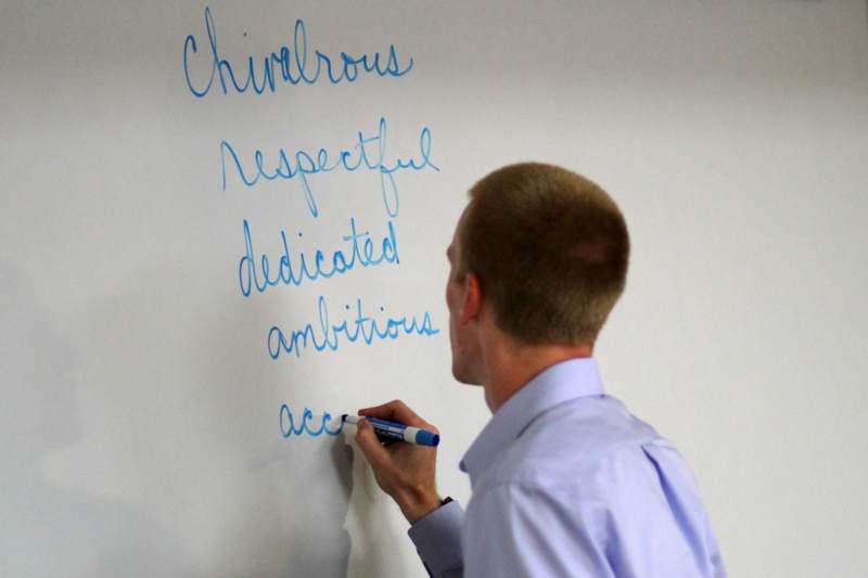 a man writing on a whiteboard