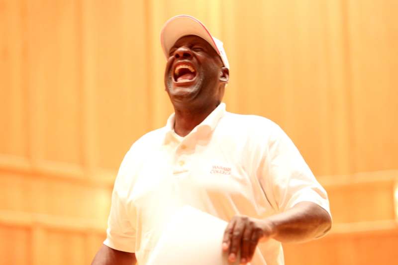 a man in a white shirt laughing
