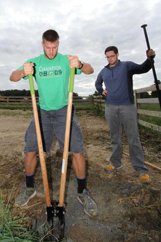 a couple of men holding shovels