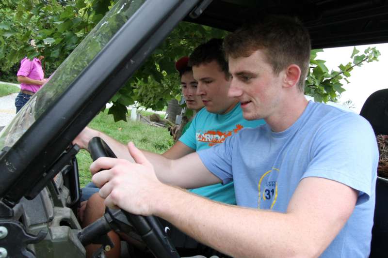 a group of men driving a vehicle