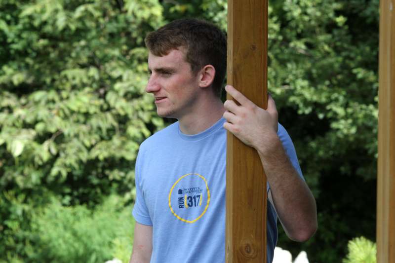 a man holding a wooden pole