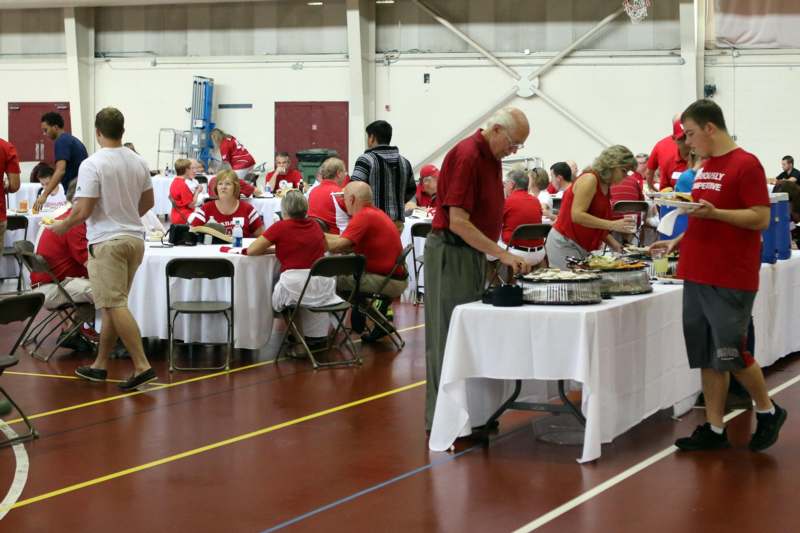 a group of people at tables with food
