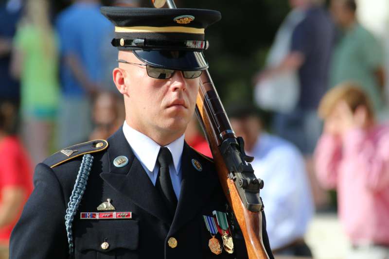 a man in a military uniform holding a rifle